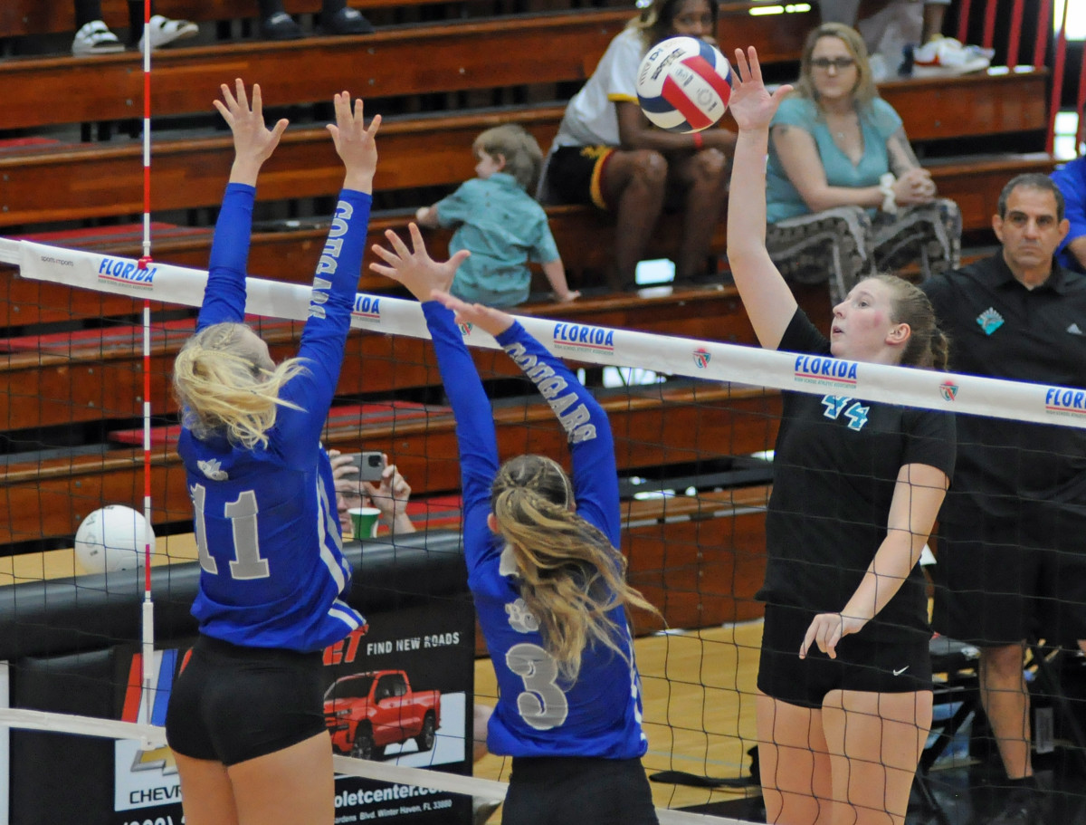 Jensen Beach senior middle hitter Lindsay Walch (44) tries to hit through the block of Barron Collier's Kendra Pruitt (11) and Chloe Goldenbaum (3) during their Class 5A state volleyball final Saturday at Polk State College. Walch had 16 kills and three blocks. Pruitt had 14 kills, while Goldenbaum had one block.